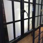 A window with bars and glass in it