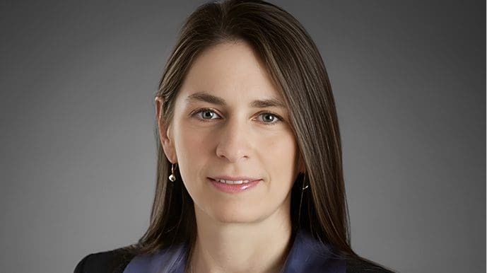 A woman with long hair wearing a blue shirt.