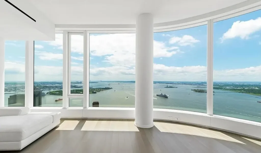 A large window overlooking the ocean and boats.