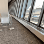 A window sill with some windows in the background