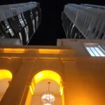 A building with two lights on the top of it