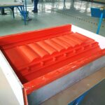 A red plastic tray sitting on top of a table.