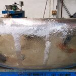 A large metal bowl sitting on top of a table.