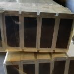 A stack of wooden boxes with some black on them