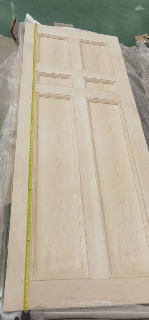 A wooden door with a measuring tape on it.