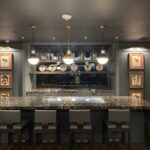 A bar with many chairs and lights above it