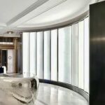 A room with many windows and a white wall