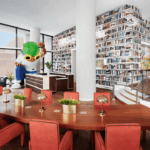 Modern library with large bookshelves and a communal wooden table.