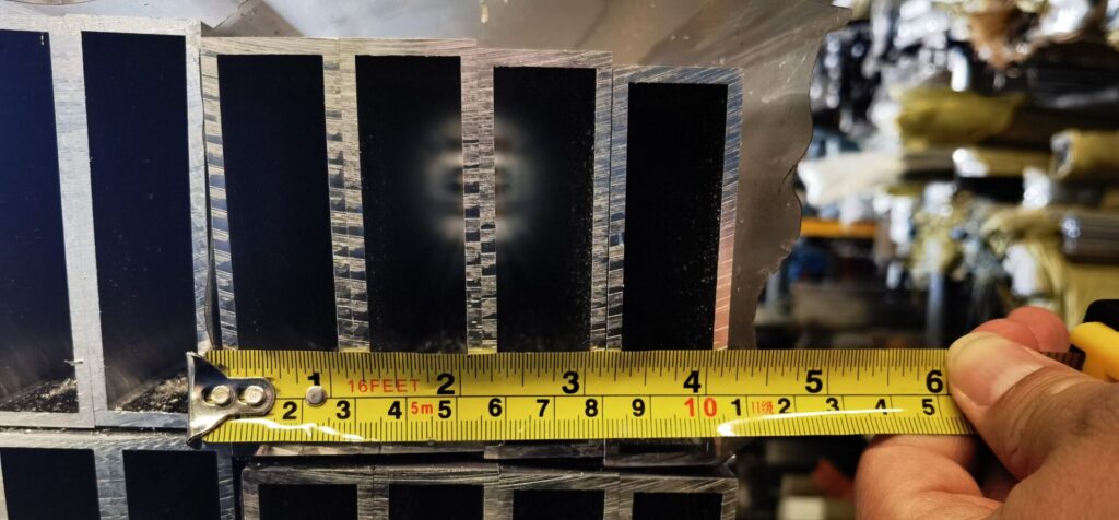 A yellow ruler is on top of some metal bars.