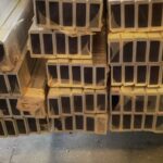 A pile of wooden beams stacked on top of each other.