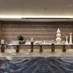 A room with many vases on the counter