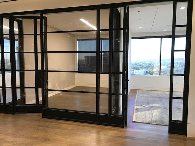 A room with glass doors and wooden floors