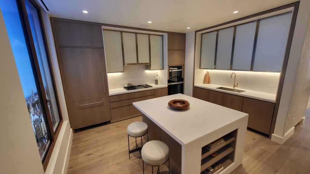 Modern kitchen with wooden cabinets and a white island.
