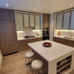 Modern kitchen with wooden cabinets and a white island.