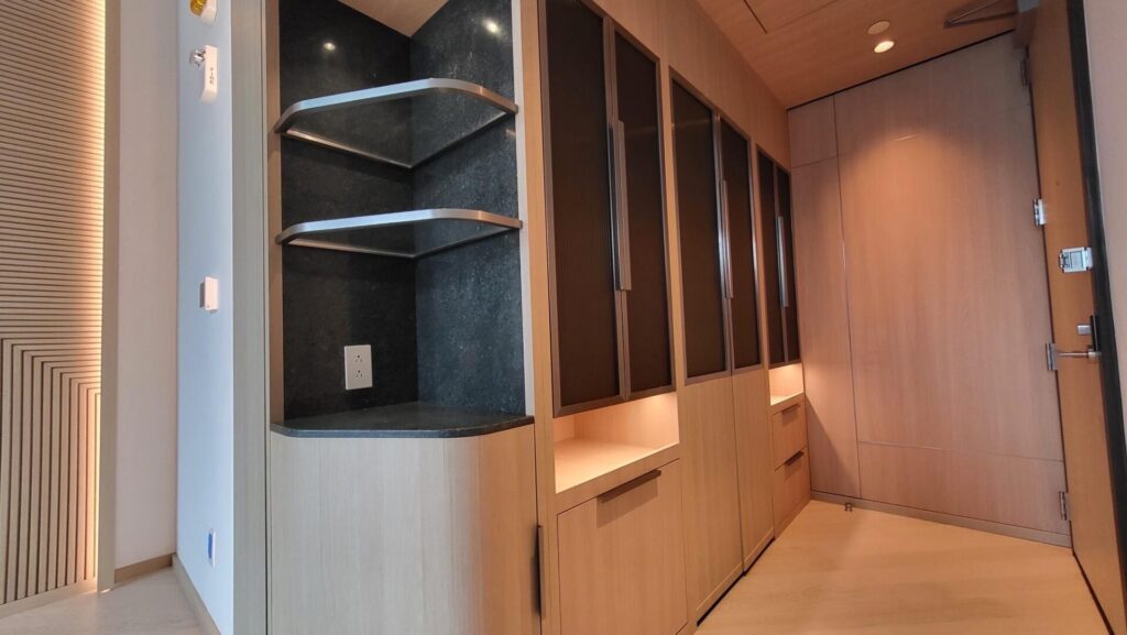 Modern wooden shelves and cabinets with LED lighting in a cozy interior.